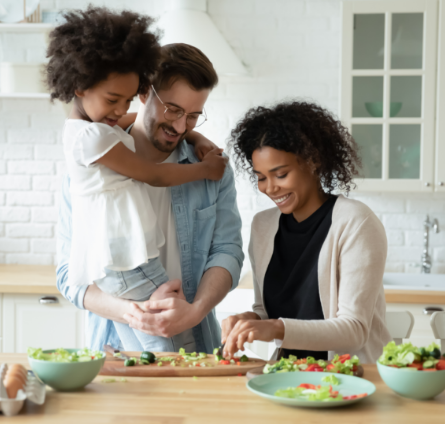 Young family making lunch at a kitchen island